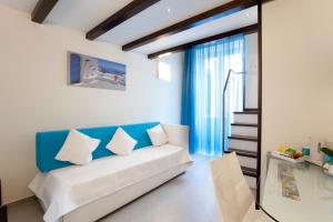 a living room with a white couch and a blue wall at Sorrento Flats in Sorrento