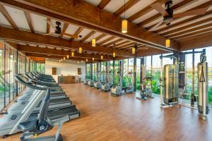 a gym with a row of treadmills and ellipticals at Andaz Mayakoba All Inclusive in Playa del Carmen