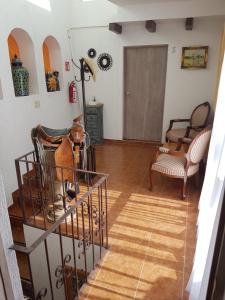 a view of a living room with a table and chairs at Hotel Tres Sofias in Querétaro