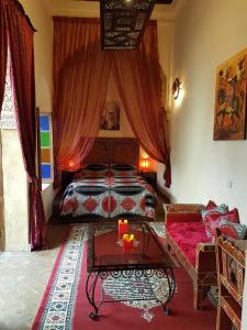 a bedroom with a bed and a table and a couch at Riad Marlinea in Sale