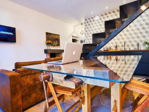 a glass table with a laptop on it in a living room at 21 Lake Sweet Home in Como