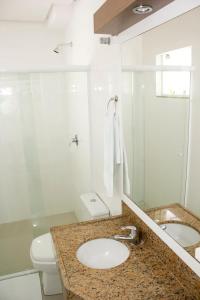 a white bathroom with a sink and a toilet at Hotel Rio Fortuna in Rio Fortuna