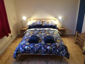 a bedroom with a bed with a colorful comforter at Ardminish House Gigha in Isle of Gigha