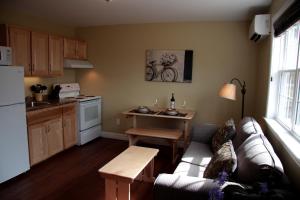 a living room with a couch and a table in a kitchen at CARLETON INN & COTTAGES in Bridgetown +37 photos