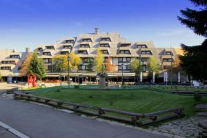 a large building with a park in front of it at Apartment Suncani Vrhovi in Kopaonik