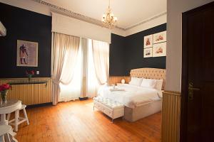 a bedroom with a white bed and a window at Tahrir Plaza Suites - Museum View in Cairo