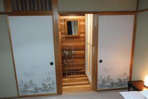 a bathroom with two sliding doors in a room at Hotel Myosen in Myoko