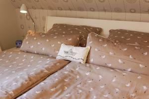 a bed with brown sheets and a pillow on it at Pier 8 in Ostseebad Karlshagen +14 photos
