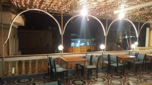 a restaurant with tables and chairs and a large mirror at High way Hotel in Tanta