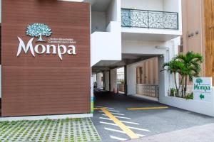 a building with a sign on the side of it at Condominium Hotel Monpa in Chatan