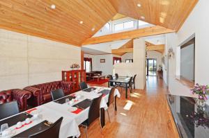 a dining room with white tables and black chairs at Sensational Heights Bed & Breakfast in Denmark