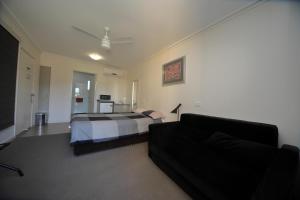 a bedroom with a bed and a couch at Black Rock Inn in Blackwater