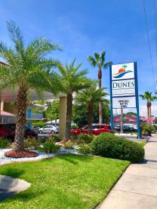 a dimes sign in front of a mall with palm trees at Dunes Inn & Suites - Tybee Island in Tybee Island