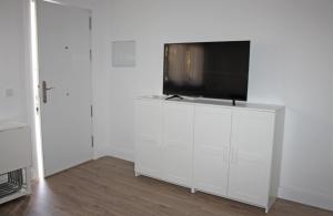 Televízia a/alebo spoločenská miestnosť v ubytovaní Apartamentos Angelita Plaza Beach