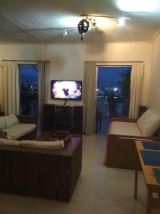 a living room with a couch and a tv at George's Apartment in Athens