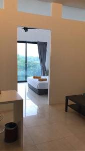 a bedroom with a bed and a large window at The Horizon Residences in Kuala Lumpur