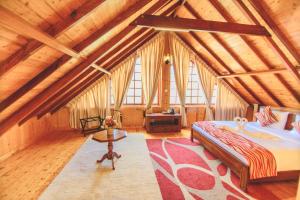 a bedroom with a bed in a wooden attic at Sarah Cottage Nuwara Eliya in Nuwara Eliya