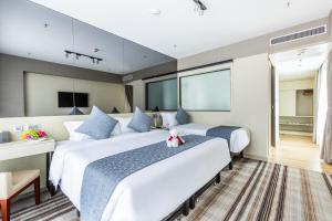 Tempat tidur dalam kamar di Eco Tree Hotel Causeway Bay