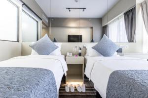 Uma cama ou camas num quarto em Eco Tree Hotel Causeway Bay