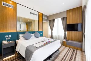 Uma cama ou camas num quarto em Eco Tree Hotel Causeway Bay