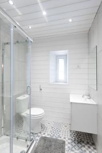 a white bathroom with a toilet and a sink at la roche gauthier 4 personnes in Gérardmer