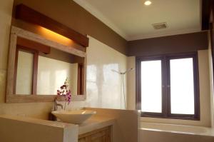a bathroom with a sink and a mirror at The Bali Shanti in Ubud +36 photos