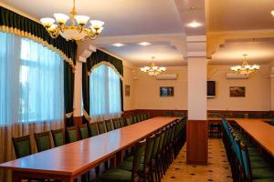 a conference room with long tables and green chairs at Vershnyk in Cherkasy