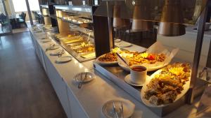 a buffet line with many different types of food at Aktea Beach Village in Ayia Napa