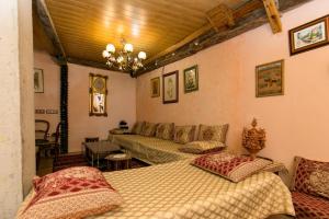 a bedroom with two beds and a couch at Charming Andalusian House in Granada