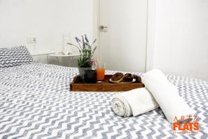 a bed with a tray of food and drinks on it at Calle Cuenca in Valencia