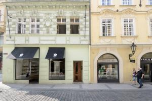 a building with black awnings on the side of a street at Stylish, Light-Filled Home in the Historic Center in Prague
