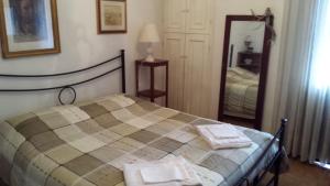 a bedroom with a bed with two towels on it at I Faggi Rossi in Fanano