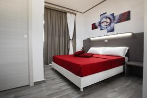 a bedroom with a bed with a red blanket at Colomba Welcome in Trapani