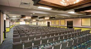 an empty lecture hall with chairs and a podium at Wyndham Garden OKC Airport - Event Center, Indoor pool, Arcade Near Paycom, Fairgrounds in Oklahoma City +78 photos