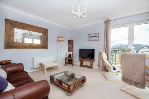 a living room with a couch and a coffee table at The View at No10 in Aviemore