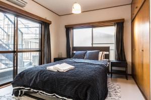 a bedroom with a bed and a large window at Ikebukuro Yamase Building #GR1 in Tokyo