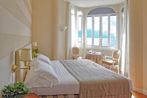 Postel nebo postele na pokoji v ubytování Lolli Palace Hotel