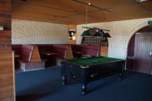 a room with a pool table and a bar at Charlton Motel in Charlton
