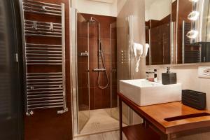 a bathroom with a sink and a shower at Luxury Experience | WelcHome Napoli in Naples +63 photos