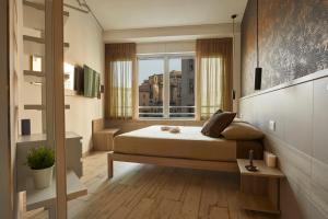 a bedroom with a bed and a window at Luxury Experience | WelcHome Napoli in Naples