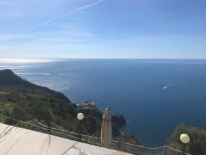 an umbrella and the view of the ocean at Albergo Luna di Marzo in Volastra