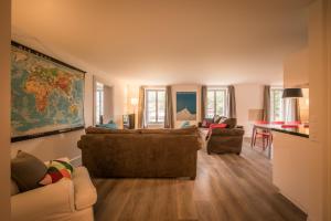 a living room with a couch and a table at Dependance Penthouse in Interlaken