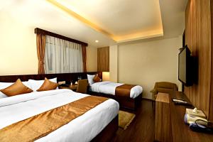 Ένα ή περισσότερα κρεβάτια σε δωμάτιο στο The Milestone Hotel