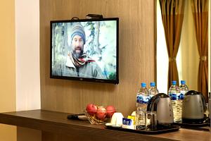 a flat screen tv hanging on a wall at The Milestone Hotel in Kathmandu +43 photos