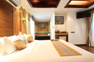 a bedroom with a large white bed in a room at Railay Village Resort in Railay Beach