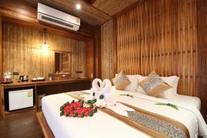 a bedroom with a bed with a flower on it at Railay Village Resort in Railay Beach