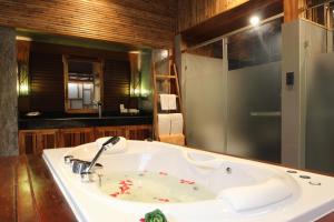 a bathroom with a white sink and a shower at Railay Village Resort in Railay Beach