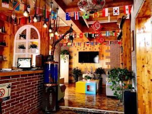 a room with flags on the wall and a room with at The Silk Road Travelers Hostel in Zhangye