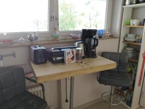 a kitchen with a table with a coffee maker on it at apartment near underground station in Munich