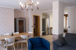 a dining room and living room with a table and chairs at Tres Puentes Anguiano Apartamentos y Hostal in Anguiano